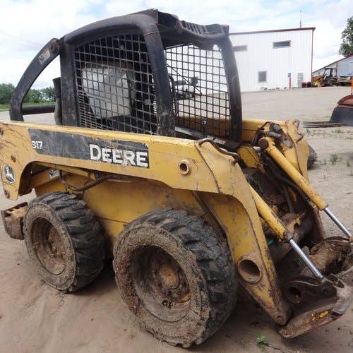 Used John Deere 317 Skid Steer Loader parts.